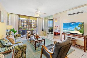 a living room filled with furniture and a flat screen tv at Kanai A Nalu 214 in Maalaea