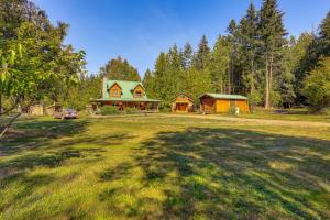 a large yard with a house and a car in front at Cabin on 5 Acres in Port Angeles with Fire Pit! in Port Angeles