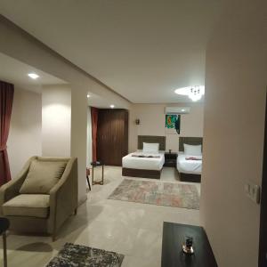 Voodi või voodid majutusasutuse Aziz Egypt Pyramids Hotel toas