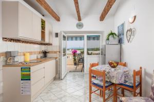 a kitchen and dining room with a table and chairs at Studio Punat 15451a in Punat