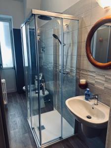 a bathroom with a glass shower and a sink at Best Stay - Central Station Suite Apartments in Bari