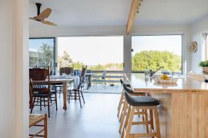 a kitchen and dining room with a table and chairs at Haven Views Harmers Haven in Cape Paterson