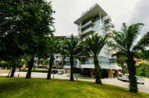 a building with palm trees in front of it at Апартаменты с видом на море на Карон Бич А 509 in Karon Beach +17 photos