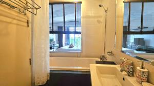 a bathroom with a tub and a sink and a mirror at Апартаменты с видом на море на Карон Бич А 509 in Karon Beach