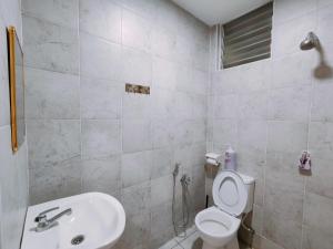 a bathroom with a toilet and a sink at A boutique Warm falim home in Kampong Pasir Puteh +48 photos