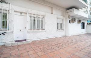 a room with a white door and a brick floor at Stunning Apartment In Fuengirola in Fuengirola