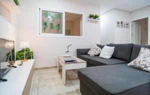 a living room with a couch and a table at Stunning Apartment In Fuengirola in Fuengirola +13 photos