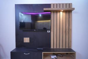 a room with a tv on a wall with a table at preferred hotel and restaurant in Roorkee +6 photos