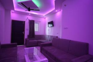 a purple living room with a couch and a table at preferred hotel and restaurant in Roorkee