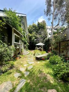 a garden with a bench and a house at Oasis Hollywood in Los Angeles +49 photos