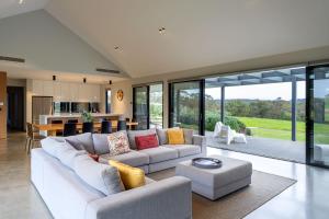 a living room with a couch and a table at Casa Nera I Private Properties in Yallingup