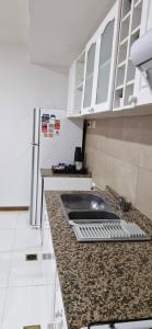 a kitchen counter with a sink and a refrigerator at DELTA SAN LUIS Departamento Centrico in San Luis +4 photos