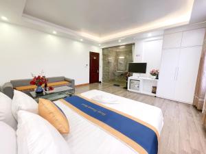 a living room with a bed and a couch at HAAP Transit Hotel in Noi Bai