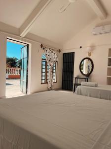 a bedroom with a bed and a large window at Villa X'Cocay in Valladolid