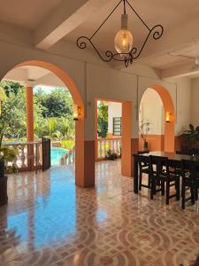 a dining room with a table and a pool at Villa X'Cocay in Valladolid