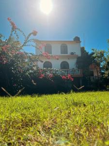 a house with a yard with flowers in front of it at Villa X'Cocay in Valladolid