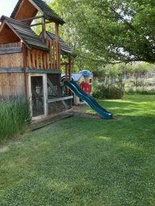 a playground with a slide in a yard at Starlight Gardens in Henrieville