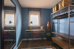a wine tasting room with blue walls and a wooden table at Loft Garmendia con PlayStation in Santander