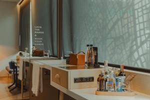 a bathroom with a counter with bottles of alcohol on it at The Click Clack Hotel Bogotá in Bogotá