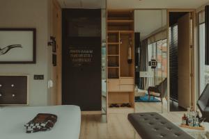 a living room with a white couch and a glass door at The Click Clack Hotel Bogotá in Bogotá