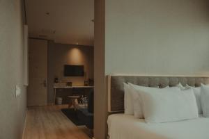 a hotel room with a bed and a living room at The Click Clack Hotel Bogotá in Bogotá