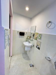 a white bathroom with a sink and a toilet at Lá Homestay Hai Phong in Ðông Khê +43 photos