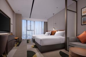 Katil atau katil-katil dalam bilik di Home2 by Suite Wuhan Qingshan