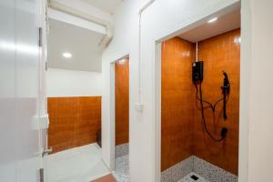 a bathroom with a shower and a phone on the wall at Yimwhan House 02, Ayutthaya old town in Phra Nakhon Si Ayutthaya