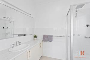 a white bathroom with a shower and a sink at Spacious 4-Bd in Cowes sleeps 8 in Cowes