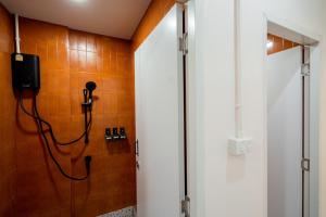 a bathroom with a shower and a phone on the wall at Yimwhan House 02, Ayutthaya old town in Phra Nakhon Si Ayutthaya