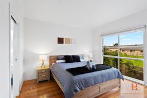 a bedroom with a bed and a large window at Spacious 4-Bd in Cowes sleeps 8 in Cowes