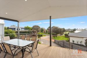 a patio with a table and chairs on a deck at Spacious 4-Bd in Cowes sleeps 8 in Cowes
