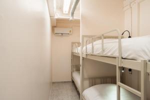 a room with two bunk beds and a window at Yimwhan House 02, Ayutthaya old town in Phra Nakhon Si Ayutthaya