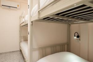 a bedroom with two bunk beds in a room at Yimwhan House 02, Ayutthaya old town in Phra Nakhon Si Ayutthaya
