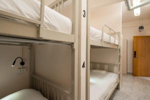 two bunk beds in a room with numbers on them at Yimwhan House 02, Ayutthaya old town in Phra Nakhon Si Ayutthaya