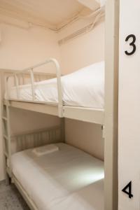 two bunk beds in a room with the number three at Yimwhan House 02, Ayutthaya old town in Phra Nakhon Si Ayutthaya