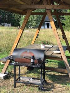 a grill sitting on a table under a tent at Aasa Summer Cottage in Surepi