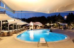 a large swimming pool in a large building at Villa Orchidea in Vittoria