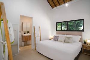 a bedroom with a white bed and a window at Two Bedroom Luxury Villa in Nusa Dua in Nusa Dua