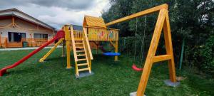 a playground with a slide and a swing set at Casa Vis Bran in Bran