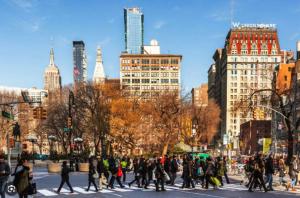 Eine Gruppe von Menschen überquert eine Straße in einer Stadt in der Unterkunft Chic One Bedroom Retreat in Downtown Manhattan in New York
