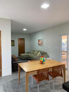 a living room with a table and a couch at Casa de Praia VILLA DAS AGUAS in Atalaia