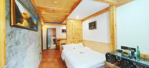 Postel nebo postele na pokoji v ubytování Dream in Fenghuang
