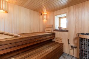 a sauna with wood paneling and a window at Pušyno apartamentai in Druskininkai +39 photos
