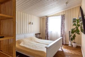 a bedroom with a bed and a window at Pušyno apartamentai in Druskininkai