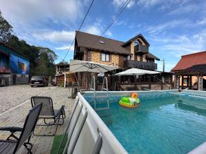 a house with a swimming pool with a toy in it at ЛемГора in Vorokhta