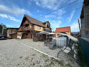 a house with a yard with chairs in front of it at ЛемГора in Vorokhta