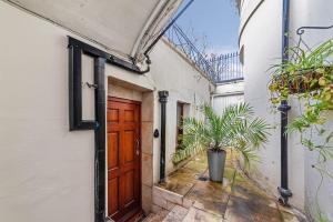 an entrance to a house with a wooden door at Cosy Little Venice Pied-à-Terre by MoreThanStays in London