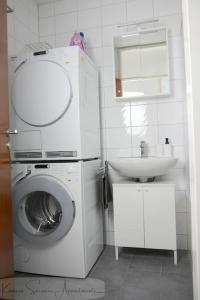 a bathroom with a washing machine and a sink at Moderne 3-Zimmer-Wohnung für bis zu 7 Personen in Friesenheim