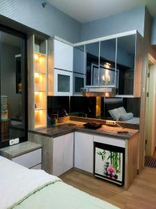 a kitchen with a sink and a counter top at Tanglin Orchard Apartment (2BR) in Surabaya